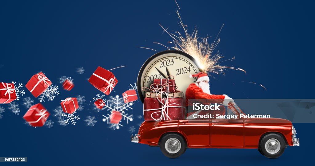 Santa Claus 2023 countdown on car Christmas is coming. Santa Claus on toy car delivering New Year 2023 gifts and countdown clock at blue background with fireworks Car Stock Photo