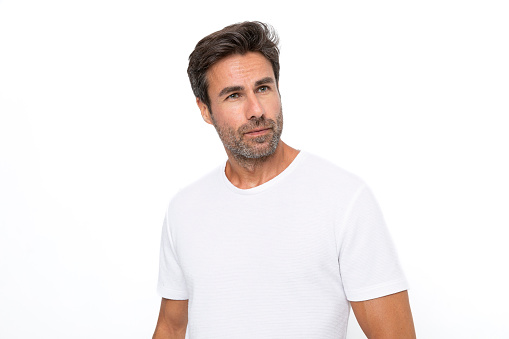 Close up of mid adult man's body in empty white t-shirt isolated on white background. Mock up for design concept. Advertising concepts. Front view.