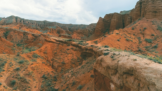 Aerial view of Mars Canyon with red mountain rock in Issyk-Kul region