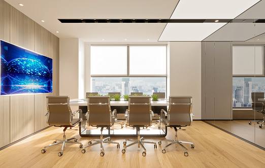 Meeting table set with white projector screen in conference room