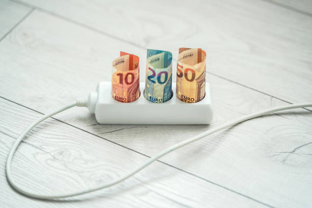 istock Euro banknotes insert in electric strip with electrical cable. 1457384045