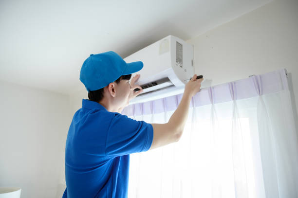 istock An Asian young Technician service man wearing blue uniform checking ,  cleaning air conditioner in home 1457384586