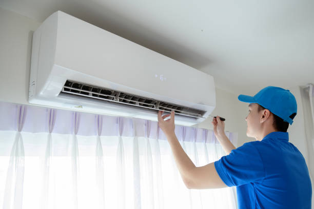 istock An Asian young Technician service man wearing blue uniform checking ,  cleaning air conditioner in home 1457384918
