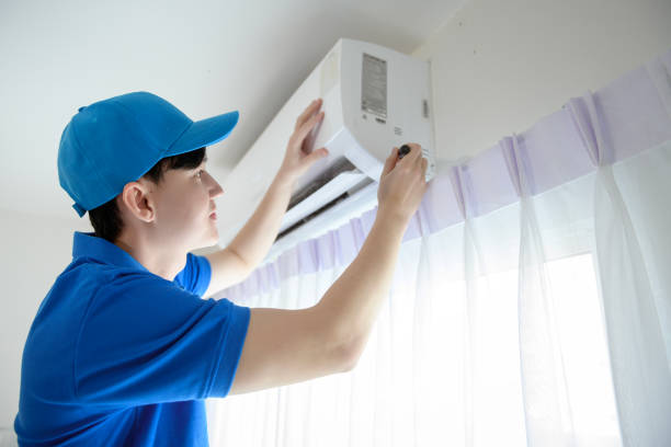 istock An Asian young Technician service man wearing blue uniform checking ,  cleaning air conditioner in home 1457384957