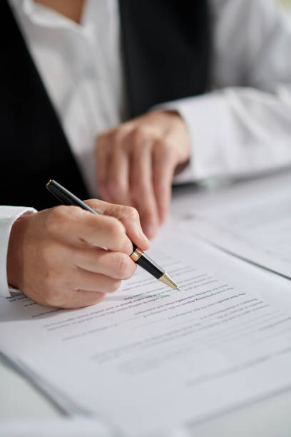 Social Worker Signing Document Closeup image of social worker signing document proof reading documents stock pictures, royalty-free photos & images