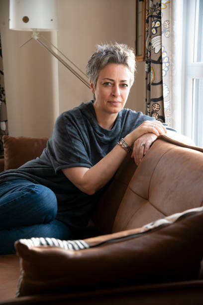 istock Woman looking out the window at home 1457385091