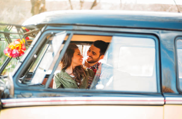 istock Woman and man enjoy in classic van. 1457385339
