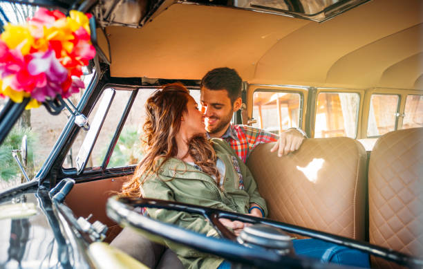 istock Woman and man enjoy in classic van. 1457385446