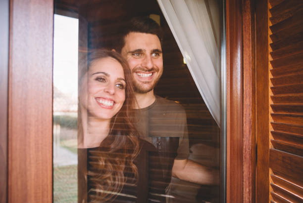 istock Man and young woman look at window. 1457385467