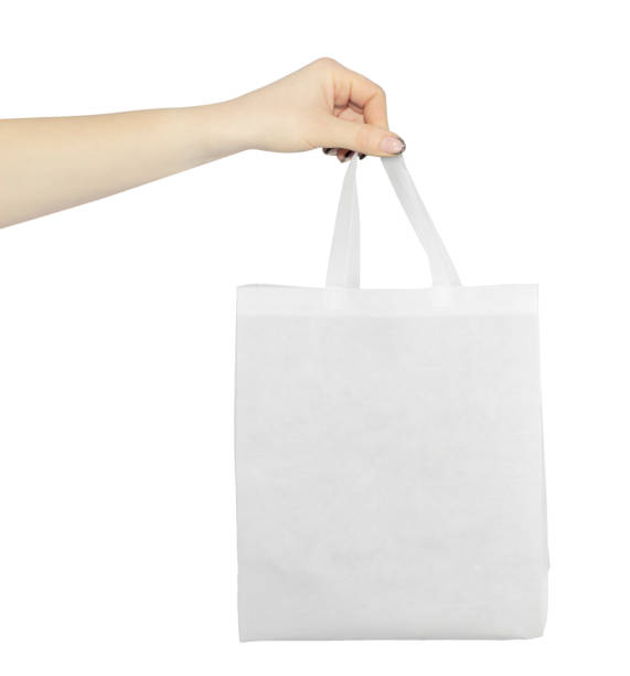 istock hand with outstretched paper gift bag 1457385960