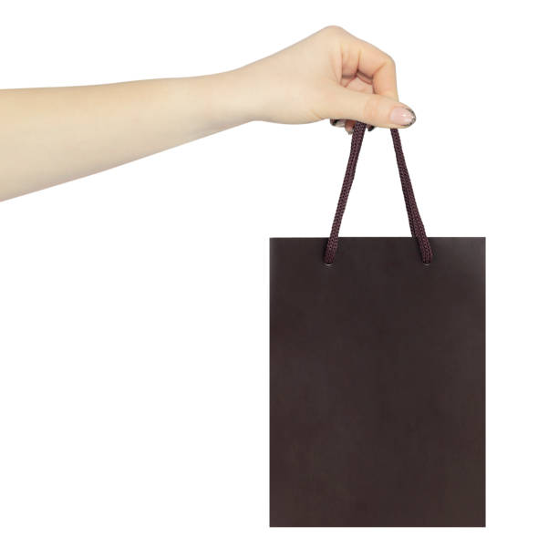 istock hand with outstretched paper gift bag 1457386735