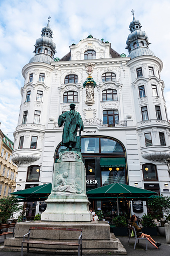 Vienna, Austria - October 14, 2022: Johannes Gutenberg monument, inventor of the printing press, with people around in Lugeck, Vienna, Austria