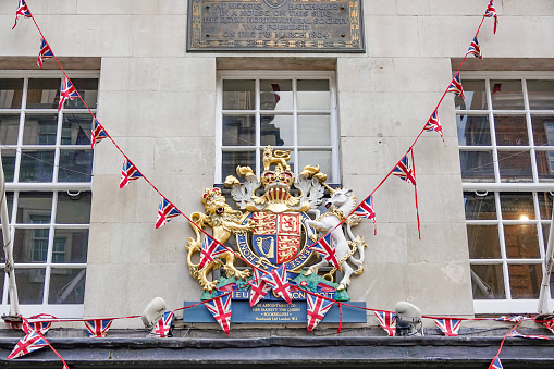 The coat of arms outside Hatchards Bookshop (1797) at the Platinum Jubilee on Piccadilly at St James's, London