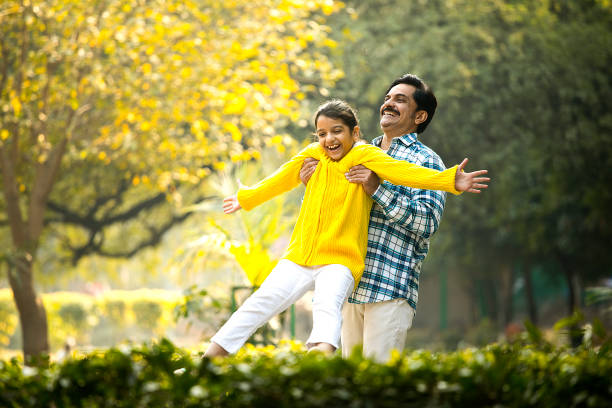istock Cheerful father playing with daughter at park 1457390214