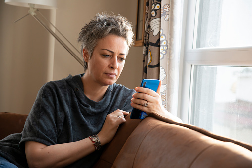Woman using mobile phone at home