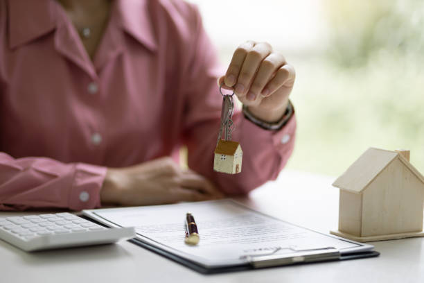 gli agenti immobiliari offrono chiavi di casa con un contratto di vendita. - landlord lease agreement real estate mansion foto e immagini stock
