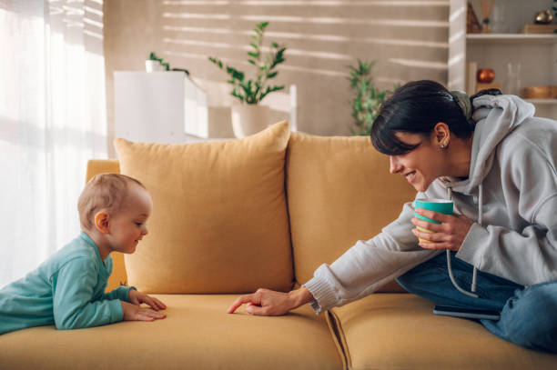 istock Mother playing and bonding with her child son and drinking coffee at home 1457391817