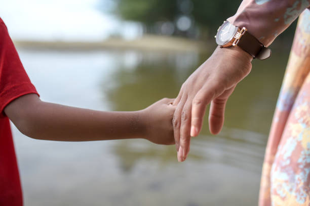istock Child's Hand Holding Mother's Hand 1457391932