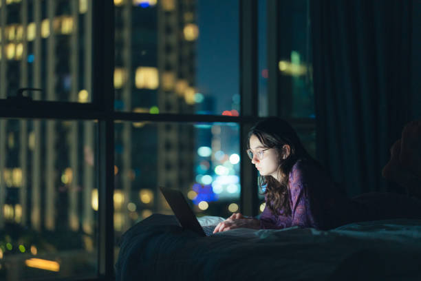istock Woman in eyeglasses working at night in megapolis 1457392063