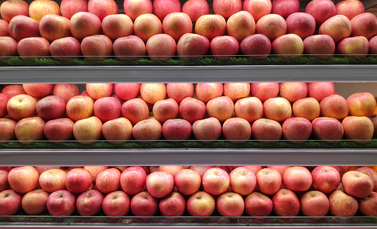Apple displayed at supermarket aisle.