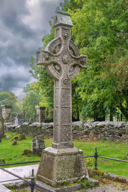 Celtic cross in a graveyard in Glendalough, Ireland