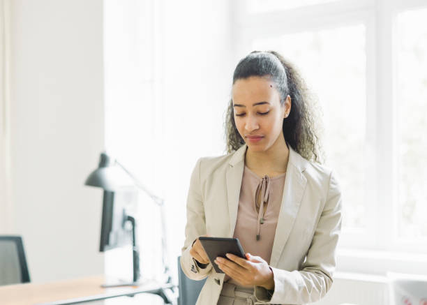 istock Confident young businesswoman using digital tablet in office 1457397032
