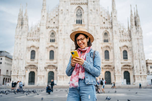 istock Young Woman Using Phone In Front Of Cathedral In Milan 1457397113