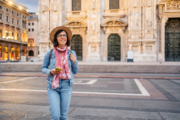 istock Young Woman Using Phone In Front Of Cathedral In Milan 1457397191