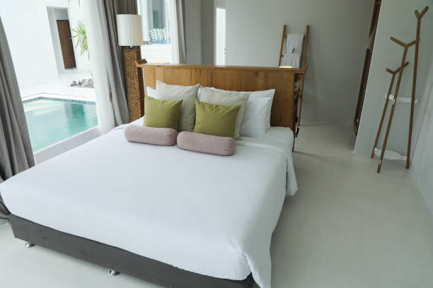 Good  white bed with pillows and blankets arranged beautifully.