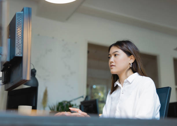 istock Young asian businesswoman working on desktop computer 1457397244