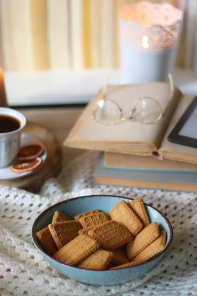istock Books, Glasses, E-Reader, Cookies, Tea and Candle 1457398084
