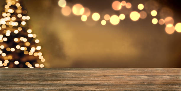 istock Christmas empty wooden table and golden bokeh lights 1457403950