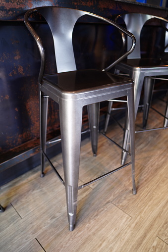 Metal black high chair with table and style wall in cafe