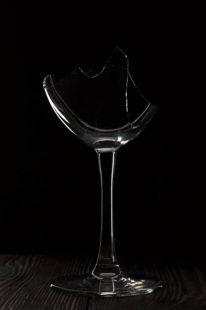istock Broken glass goblet. Stands on black boards. Shot on a black background. 1457406290
