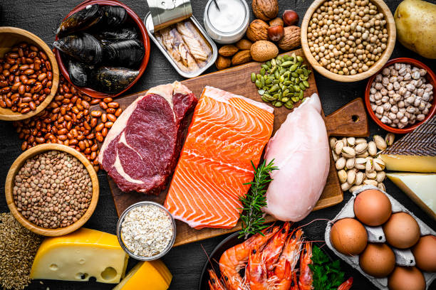 Food rich in healthy proteins Overhead view of a large group of food with high content of healthy proteins. The composition includes salmon beef fillet, chicken breast, eggs, yogurt, mussels, chick peas, pistachios, cheese, brown lentild, beans, shrimps, canned tuna, pumpkin seeds, soybeans among others. High resolution 42Mp studio digital capture taken with SONY A7rII and Zeiss Batis 40mm F2.0 CF lens Protein stock pictures, royalty-free photos & images