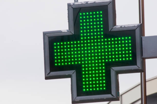 istock Pharmacy sign,  green cross symbol. 1457413212