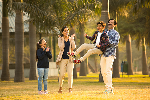 Happy Indian family spending leisure time together at park