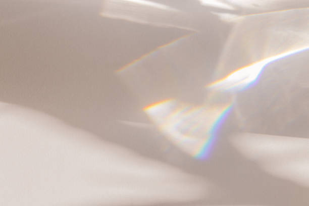 istock Sunlight background, abstract photo with light and shadow, glare and shine on paper texture, rainbow flare, beige monochrome minimal scene. Natural light and caustic effects, trend aesthetic 1457417092