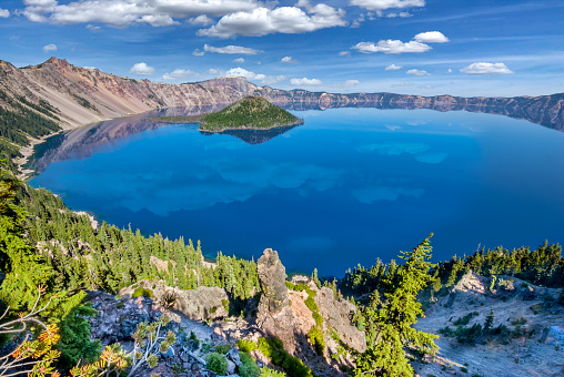 Crater Lake exists in the blown-out caldera of a once mighty volcano known as Mount Mazama.  This view of the lake and Wizard Island was taken from the Rim Trail in Crater Lake National Park, Oregon, USA.