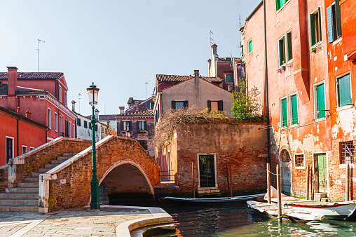 Old colorful architecture on the canal with bridge in Venice, Italy. Beautiful european cityscape.