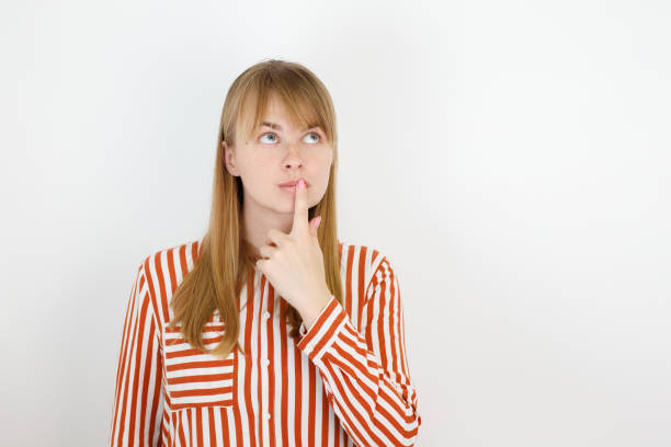 istock woman 30 years old looks up thoughtfully 1457420829