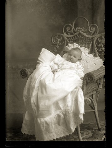 Beautiful Black and White portrait of a baby wearing Victorian-era Christening clothing. The image was digitally restored from a glass plate taken circa 1890.