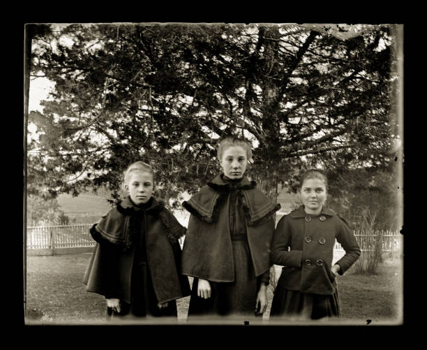 istock Victorian-era Girls Wearing Winter Cloaks, Circa 1890 1457421290