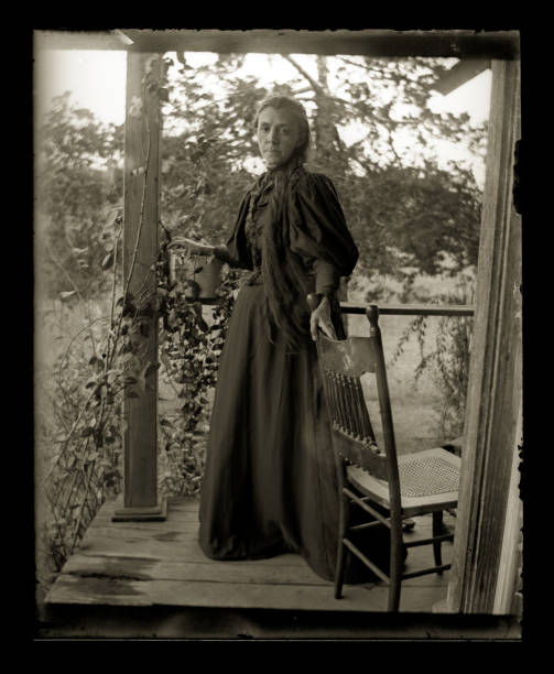 The Farmer's Wife, Circa 1890 Beautiful Black and White portrait of an American Farmer woman wearing Victorian-era clothing. Taken on the front porch of her farmhouse dressed in her best clothes--probably on a Sunday afternoon. The image was digitally restored from a glass plate taken circa 1890. the farmer and his wife pictures stock illustrations