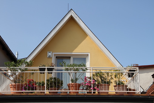 a balcony with flowers and plants