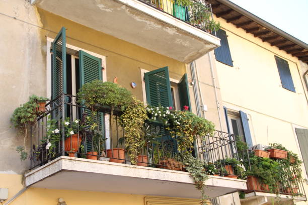 a balcony with flowers and plants