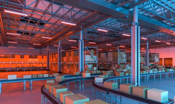 Conveyor belts transporting boxes in a large warehouse full of merchandise, night time