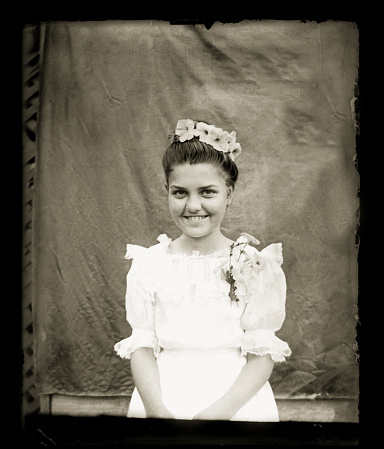 Beautiful Black and White portrait of a young woman wearing Victorian-era clothing. The image was digitally restored from a glass plate taken circa 1890.