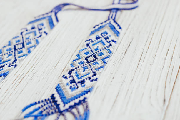 A close-up view of an element of a Ukrainian men's embroidered shirt. Ukrainian traditional embroidery is made in blue tones.