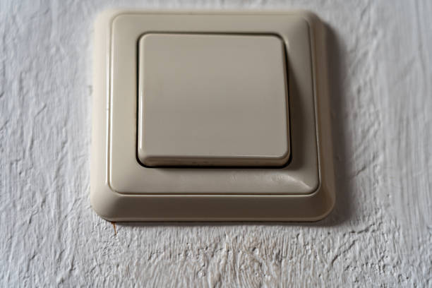 istock Light switch on the white wall to turn on the light 1457425988